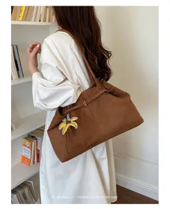 Soft large capacity tote bag for women, vintage casual shoulder bag with pendant detail.