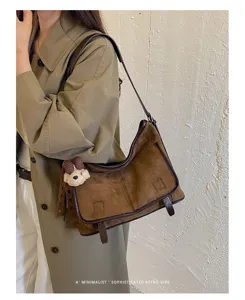 Stylish retro brown suede shoulder bag with cute bear pendant for women daily casual wear.