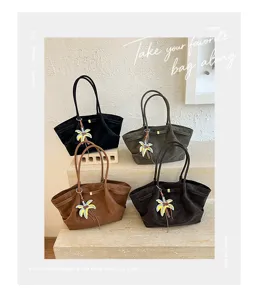 Detail shot of four vintage tote bags with palm charms in multiple colors for daily commute.