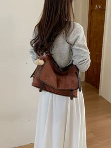 Brown suede shoulder bag for women, stylish crossbody messenger bag for daily wear and fashion.