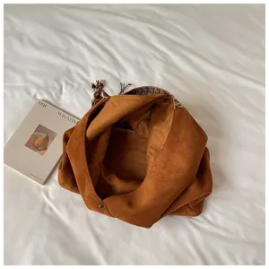 Retro brown suede hobo dumpling bag detail showing spacious interior, texture and boho strap.