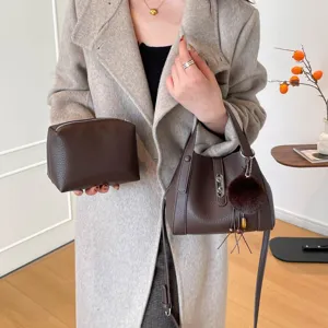 Stylish women's leather bucket bag and pouch set with pebble grain texture and chic shoulder strap.