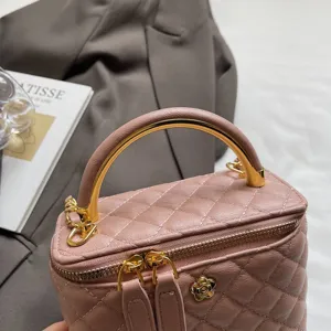 Pink quilted vanity handbag with metal top handle and chain strap for women chic daily use.
