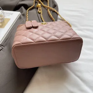 Pink quilted leather crossbody bag with gold chain strap, stylish chic shoulder handbag.