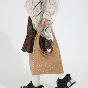 Stylish rivet shoulder bag for women, trendy brown hobo handbag with metal studs for daily use.
