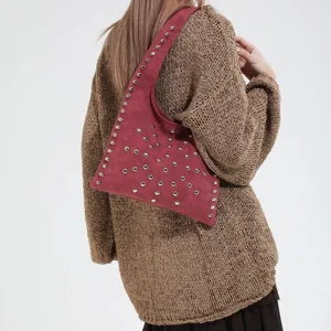 Trendy studded suede shoulder bag for women, stylish underarm handbag for winter fashion.