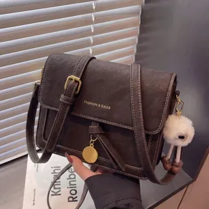 Vintage brown shoulder bag for women, stylish crossbody small square bag with chic pendant.