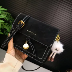 Black vintage leather crossbody bag, retro small square shoulder bag with fluffy doll pendant.