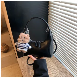 Stylish black PU leather hobo shoulder bag with cute plush dog keychain for women.