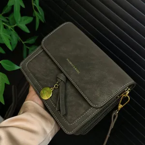 Vintage crossbody shoulder bag detail view with tassel pendant and gold hardware finish.