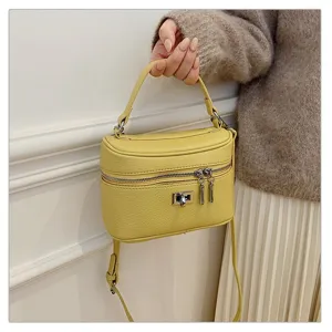 Stylish yellow leather top handle box bag, versatile vintage shoulder crossbody bag for women.