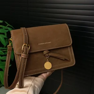 Vintage brown small square shoulder crossbody bag with elegant flap and metal pendant.