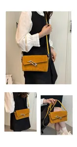 Stylish yellow suede crossbody bag with metallic lock closure, perfect for daily commuting.