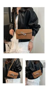 Detail view of the brown suede crossbody shoulder bag with metal lock hardware and clean stitching.