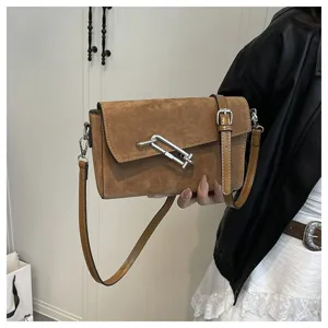 Brown suede shoulder bag for women, stylish crossbody bag with metal lock clasp detail.
