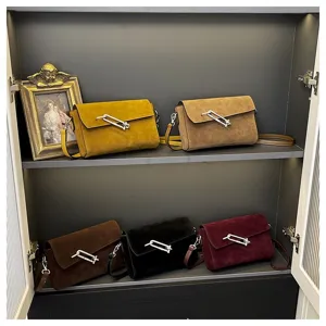 Detailed view of fashionable suede shoulder crossbody bags, casual niche commuting small square bags.