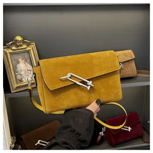 Detailed view of yellow suede cross body bag with metal clasp for women commuting daily wear