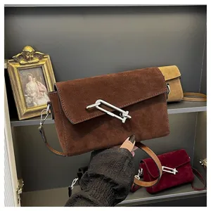 Brown suede crossbody bag for women, stylish shoulder bag with metal lock hardware and compact design.