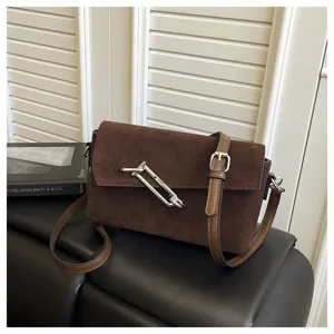 Brown suede shoulder crossbody bag with metal lock detail for women commute and casual style.