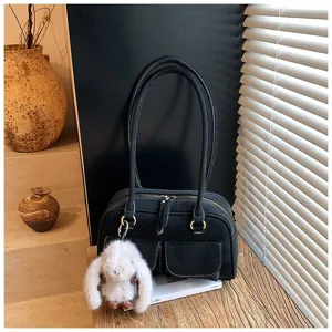 Classic black vintage shoulder handbag with cute plush rabbit pendant, large capacity commuter bag.