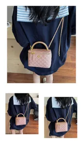 Pink quilted chain vanity bag detail view, showing elegant leather texture and metal handle.