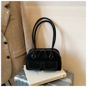 Detailed closeup view of vintage black shoulder bag with dual straps and front utility pockets.