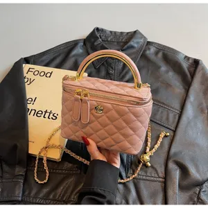 Classic pink quilted leather vanity handbag with gold handle and chain strap for women.