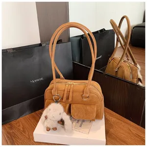 Brown retro handbag detail showing dual zipper compartments, front pockets and cute fluffy bunny.