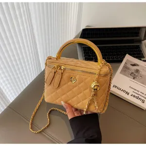 Quilted khaki vanity handbag with gold handle and chain strap, elegant detail view design.