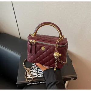 Chic quilted vanity handbag with metal top handle and chain strap for women elegant use.