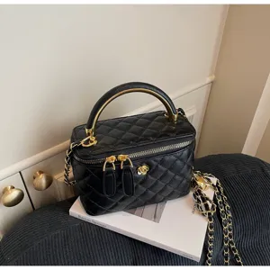 Elegant black quilted vanity handbag with gold hardware, top handle, and chain strap for daily use.