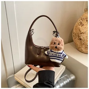Retro brown crescent shoulder bag with cute plush dog charm, stylish daily crossbody bag.