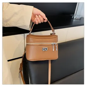 Detailed view of textured leather surface and shiny metal hardware on this stylish retro handbag.