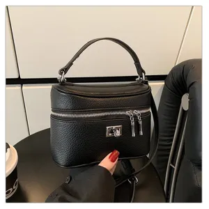 Black retro top handle box bag for women, elegant PU leather crossbody handbag with lock.
