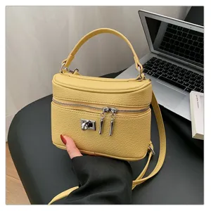 Yellow retro leather crossbody box bag for women, stylish top handle commuting shoulder bag.