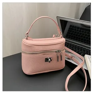 Pink faux leather vanity box bag detail, featuring textured finish and silver hardware.