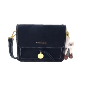 Black vintage crossbody shoulder bag for women with contrast white stitching and cute furry doll.