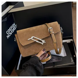 Trendy brown suede shoulder bag with stylish metal hardware clasp for women commute daily use.