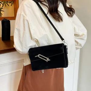 Black suede shoulder bag for women, stylish crossbody bag with metal lock clasp design.