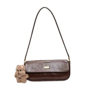Vintage brown baguette shoulder bag for women, stylish winter small underarm handbag.