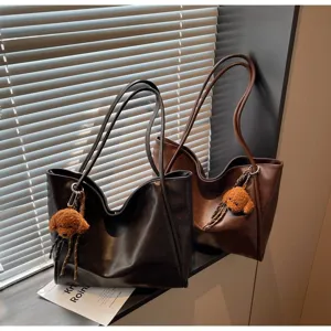 Casual large capacity PU leather tote bag with cute plush puppy pendant for daily commuting.
