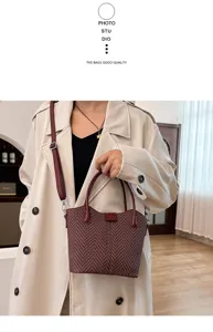 Close-up detail of stylish women's textured bucket handbag with adjustable shoulder strap.
