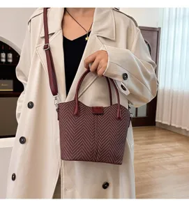 Detailed view of autumn winter retro woven texture handbag with shoulder strap and chic design.