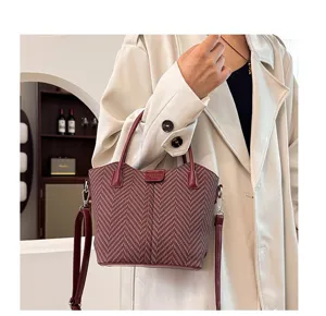 Detailed view of women's houndstooth PU leather crossbody handbag, stylish and compact design.