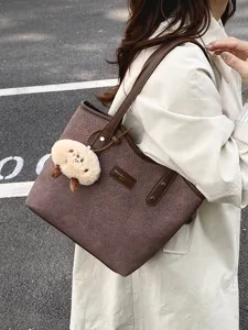 Detail view of the stylish brown woven tote bag showcasing its spacious capacity and plush charm.