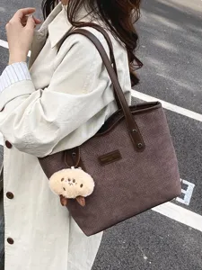 Detail view of the stylish woven tote bag showing the textured fabric and PU handle.