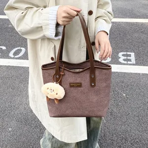 Casual commuter tote bag for women, large capacity PU leather handbag with cute plush charm.