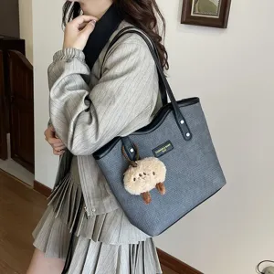 Stylish grey PU woven tote bag for women, large capacity commuter shoulder bag with plush pendant.
