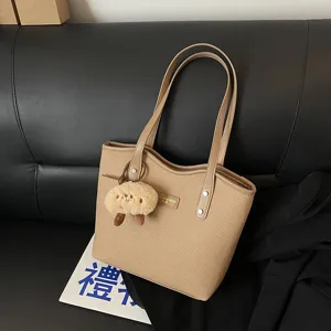 Large capacity PU leather tote bag for women, stylish commuting shoulder bag with cute plush pendant.