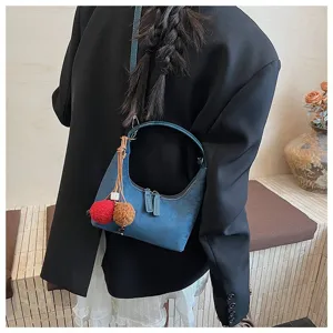 Classic dark blue suede dumpling shoulder bag with plush pom-pom charms for women stylish daily wear